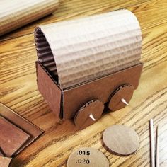 a cardboard train is sitting on the table next to some paper circles and other crafting supplies