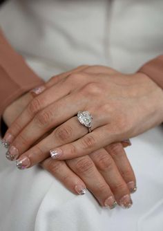 a close up of two people holding hands with wedding rings on their fingers and the other hand