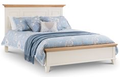 a bed with blue and white comforter on it's headboard is shown