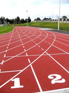 a red running track with white numbers on it