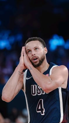 a basketball player holding his hand to his face