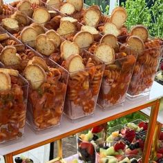 several plastic containers filled with food sitting on top of a table next to other foods