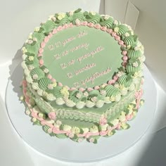 there is a cake that has been decorated with flowers and words on the top layer