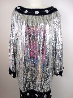 "This beautiful vintage piece fully embellished with reflective mirror silver sequins and jewels on silk and fully lined. It's in excellent condition! (note, I was wearing a pink shirt while photographing and the color reflects in the sequins) Bust - 58\" Waist - 44\" Hips - 42\" Length - 34\" All of my items come from a smoke-free and pet-free home. If you have any questions, please don't hesitate to ask!" Silver Embellished Sequin Fabric For Night Out, Glamorous Embellished Sequin Dress For Festive Season, Disco Embellished Sequin Dress For Party Season, Disco Style Embellished Sequin Dress For Party Season, Disco-style Embellished Sequin Dress For Party Season, Silver Sequin Fabric With Rhinestones For Evening, Party Season Disco Embellished Sequin Dress, Bedazzled Sequin Dress For Evening Parties, Glamorous Festive Sequin Fabric With Rhinestones