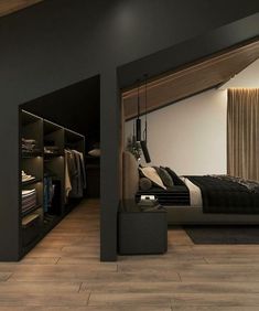 a bedroom with black walls and wooden flooring is shown in this image, there are closets on either side of the bed