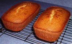 two loafs of bread sitting on top of a cooling rack