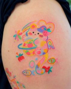 a woman with colorful tattoos on her arm and shoulder, has an image of a monkey holding a bowl of fruit