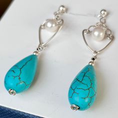 Enjoy the beauty of Natural Spiderweb Turquoise teardrop sterling silver earrings. These stunning, elegant and stylish earrings are mounted on solid 925 Sterling Silver ball stud with butterfly closure. Known for its intense blue color with little to no matrix, it makes jewelry of incredible beauty and value! The Turquoise earrings are complimented with a 6 mm Freshwater pearl that adds class to every outfit! Natural Turquoise earrings will make a unique gift for anyone's birthday, anniversary o Elegant Turquoise Drop Teardrop Earrings, Elegant Turquoise Pierced Earrings, Elegant Turquoise Teardrop Earrings As Gift, Elegant Turquoise Teardrop Pierced Earrings, Turquoise Sterling Silver Teardrop Dangle Earrings, Turquoise Teardrop Pearl Drop Earrings, Hypoallergenic Turquoise Sterling Silver Teardrop Earrings, Hypoallergenic Turquoise Teardrop Earrings In Sterling Silver, Elegant Turquoise Teardrop Earrings