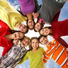 a group of young people standing in a circle with their mouths open and looking up at the camera