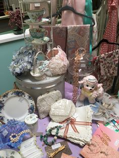 a table topped with lots of different types of cloths and knick knacks