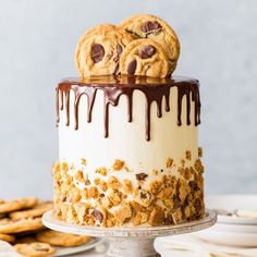 chocolate chip cookie cake with white frosting and cookies on top