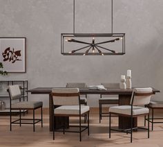 a dining room table with four chairs around it