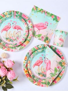 flamingo themed party plates and napkins with pink roses on the table next to them