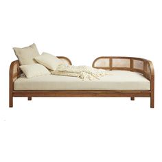 a day bed with pillows and blankets on it's sides, against a white background