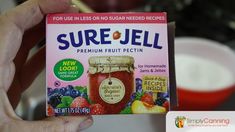 someone holding up a box of sure - jell fruit pectin for sale