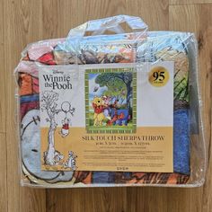 the winnie the pooh blanket has been wrapped in plastic and is ready to be used