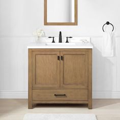 a bathroom vanity with a mirror above it and a rug on the floor next to it