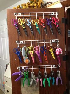 there are many pairs of scissors hanging on the wall