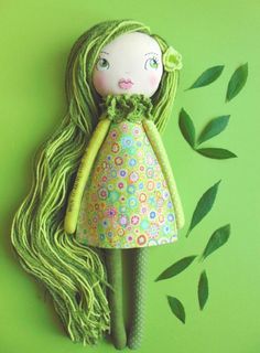 a doll with long hair and green dress