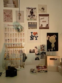 a white desk topped with lots of pictures and magnets