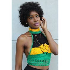 a woman wearing a halter top with crochet on the sides and a cell phone to her ear