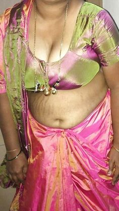 a woman in a pink and green sari