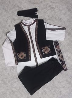 For the boys who love to look good with an ethnic twist, we have our stylised Armenian taraz set which includes: - A head tie - A shirt - A pair of pants - A vest - A tie belt Colors can be customised. Sizes available. Traditional Black Festival Sets, Fitted Sets With Traditional Patterns For Festival, Black Cotton Sets With Traditional Patterns, Fitted Festival Sets With Traditional Patterns, Casual Cotton Festival Set, Casual Cotton Sets For Festival, Festive Folk Style Sets With Traditional Patterns, Festive Folk Sets With Traditional Patterns, Tie A Shirt