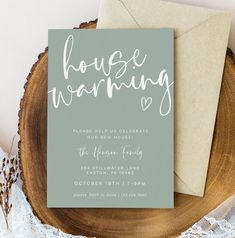 this is an image of a house warming card on top of a wood slice with lace