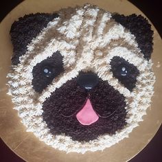 there is a cake that looks like a pug face on the top of it