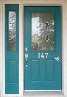 a blue front door with the number forty seven on it