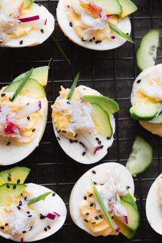 several deviled eggs with toppings are on a wire rack and there is the title above it