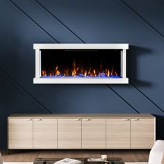 a living room with blue walls and a fireplace in the center, along with a white entertainment unit