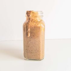 a jar filled with brown liquid sitting on top of a table