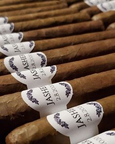 cigars are lined up in rows with labels on them