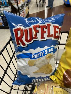 a bag of ruffle party size chips sitting in a shopping cart next to a banana