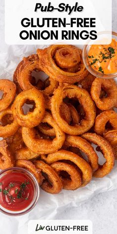 a pile of onion rings with dipping sauce