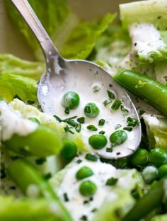 a salad with peas, lettuce and sour cream