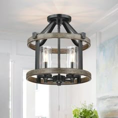 a chandelier hanging from the ceiling in a room with white walls and wood accents