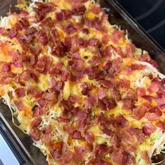 a casserole dish with bacon and cheese on top