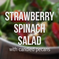 a bowl filled with spinach salad and topped with pecans on the side text reads strawberry spinach salad with candied pecans