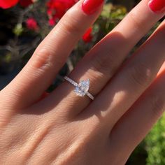 a woman's hand with a diamond ring on it