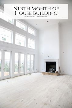 an empty living room with white walls and windows