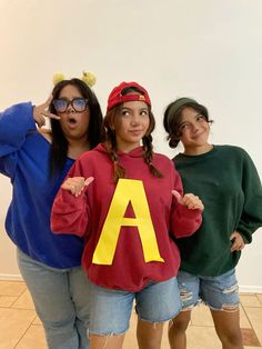 three girls in costumes posing for the camera