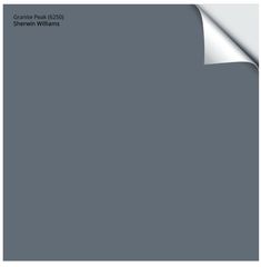 an image of a gray wall with white paper on the top and bottom half of it