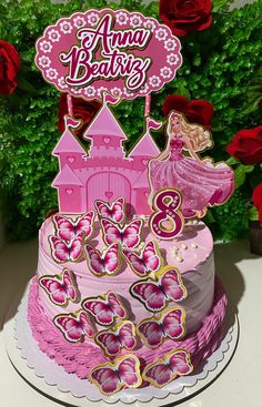 a birthday cake with pink frosting and decorations