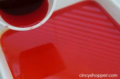 red liquid being poured onto a white tray