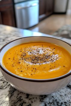 A bowl of creamy orange soup topped with black pepper on a marble countertop. Navy Bean Soup Recipes, Navy Bean Soup, Soup Lovers