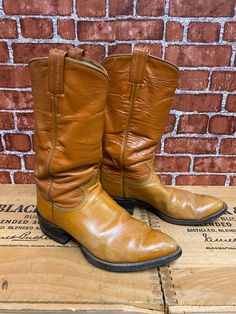 "Vintage Tony Lama western cowboy boots size 7?, two tone brown color. Good used condition, some wear, minor scuffing on the pointed toes, made in Usa. Please, check carefully the measurements, photos and description of the article before buying it, we do not accept changes or returns. Outsole Approximate Dimensions: 11\" long heel to toe. 10\" Inside from the heel to the toe. 3 3/4\" Widest wide in front of footwear. 1 1/4\" Tall heel. 12 1/4\" Tall total. Let me know if you have any questions Western Brown Work Boots For Western-themed Events, Brown Western Work Boots For Western-themed Events, Western Style Brown Work Boots, Fitted Vintage Brown Western Boots, Southwestern Brown Snip Toe Boots, Brown Southwestern Snip Toe Boots, Western Brown Snip Toe Work Boots, Western Brown Work Boots With Snip Toe, Brown Western Work Boots With Snip Toe