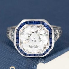 Only beyond obsessed with this antique target ring, set with a gorgeously faceted old European cut diamond, sparkling brightly against the velvety blue sapphires. Highly sogt after, this would make for a true one of a kind engagement ring (plus, she looks like a million bucks on the finger!). Platinum Size 4 & resizable Diamond measures 8.61 - 8.71 x 5.45 mm GIA link here Video Below Rose Cut Sapphire Cluster Ring, Antique Sapphire Jewelry With Single Cut Diamonds, Timeless Sapphire Diamond Ring With Rose Cut Diamonds, Timeless Sapphire Diamond Ring With Rose Cut, Sapphire Diamond Ring With Rose Cut Diamonds, Timeless Sapphire Ring In Diamond White, Lab-created Sapphire Diamond Ring With Diamond Cut, Sapphire Cluster Ring With Rose Cut Diamonds, Timeless Sapphire Ring In White