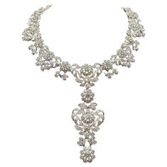 Elevate your jewelry collection with this exquisite Edwardian diamond necklace, meticulously crafted from 18-kt white gold. This custom vintage piece boasts an impressive 35.97-carats of diamonds, radiating timeless elegance and sophistication. The necklace features a detachable centerpiece pendant, allowing versatile styling options to suit any ensemble.